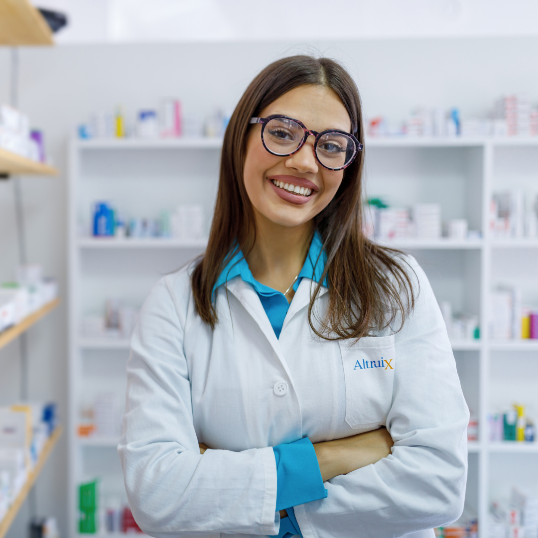 Altruix pharmacist standing in front of pharmacy shelves with arms crossed