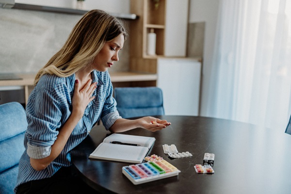 Woman using medication adherence technology